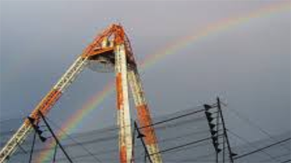 Metal equipment against sky with rainbow