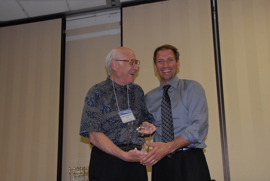 Gerald Jerry Romick (formerly U AK) the first CEDAR chair, receives his award from the 12th (present) CEDAR Chair