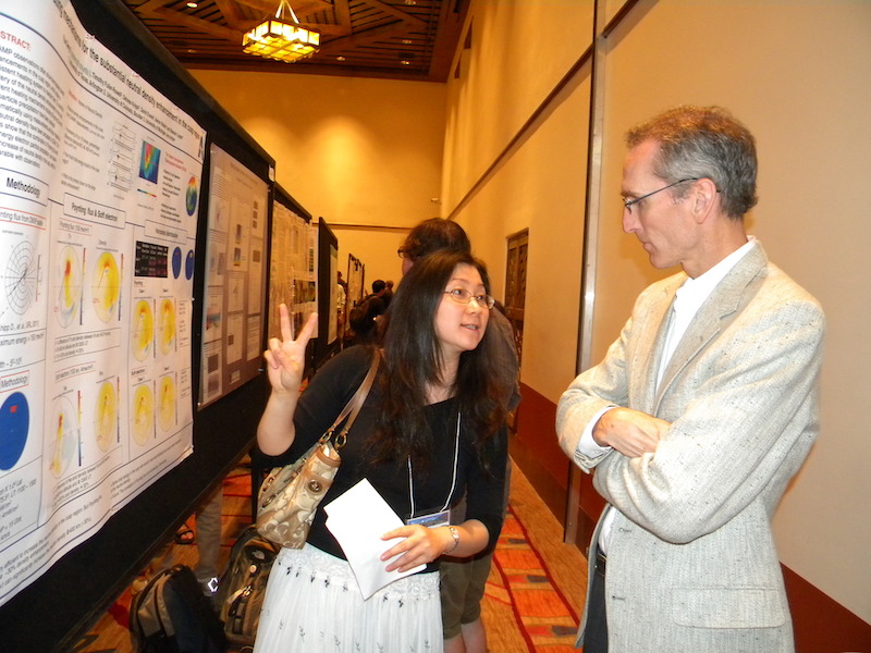 Yue Deng of the University of Texas at Austin explains her POLA-07 poster to Greg Earle formerly of the University of Texas at Dallas but now at Virginia Tech.