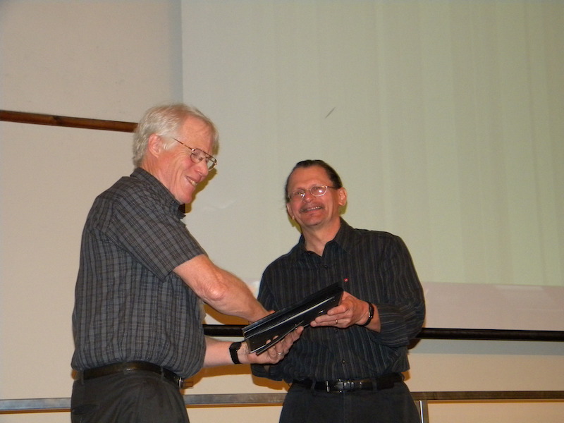 The 2011 CEDAR prize winner Joe Huba of the Navel Research Lab receives a plaque from CEDAR chair John Foster of MIT/Haystack Observatory.