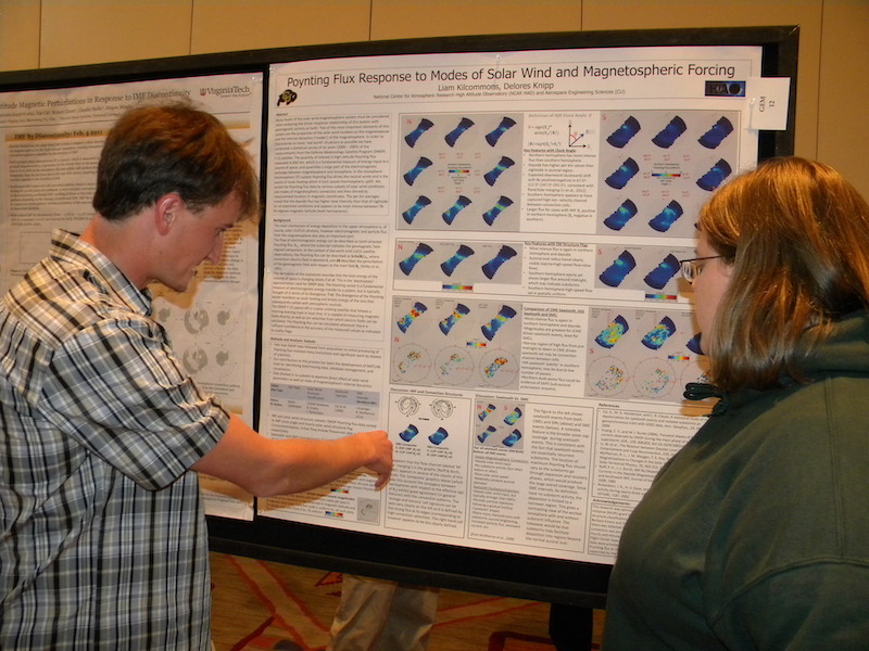 Liam Kilcommons of the University of Colorado and HAO/NCAR explains his GEM-IT poster to Elizabeth Mitchell of NASA Goddard Space Flight Center.
