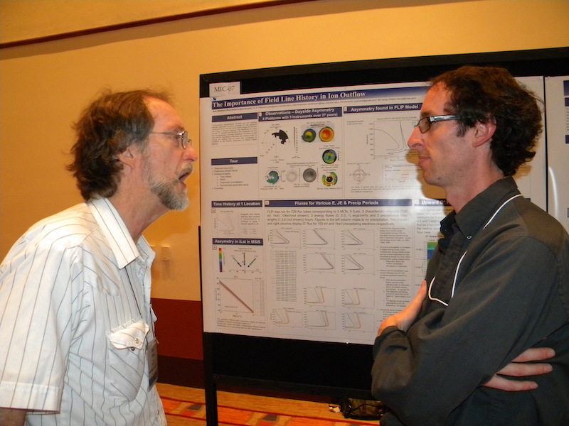 Rob Redmon of the University of Colorado and NGDC/NOAA at his MIC-07 poster listens to GEM participant David Cooke of the Air Force Research Lab.