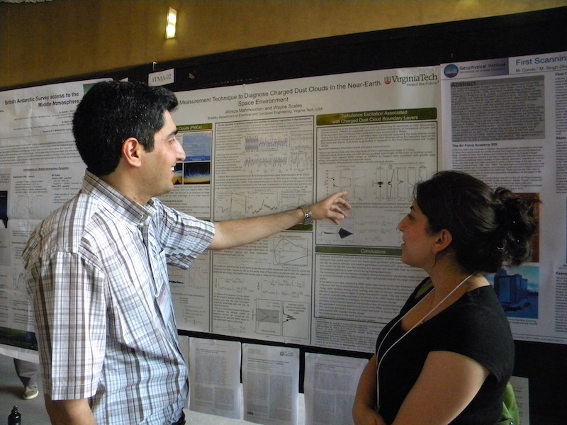 Alireza Mahmoudian of Virginia Tech explains his ITMA-02 poster to Romina Nikoukar of Augsburg College.