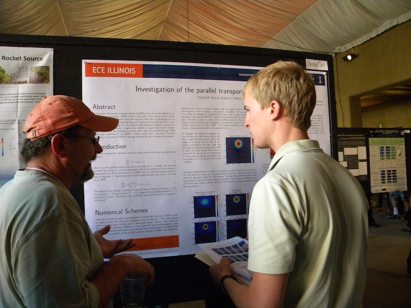 Tim Duly of U IL and new student CSSC representative explains his MDIT-07 poster to Joe Huba of NRL.