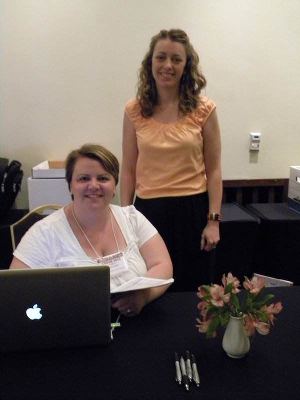 Carrie Appel (seated) and Kendra Greb of the Visiting Scientist Program at NCAR behind the CEDAR 2012 registration desk in the Eldorado Hotel.