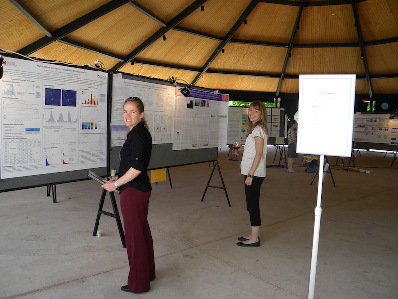 Ellen Cousins (HAO/NCAR) is a judge for the IT student poster competition Tuesday 25 June 2013 with Kendra Greb (VSP/UCAR) who helped organize the poster materials and layout in the background.