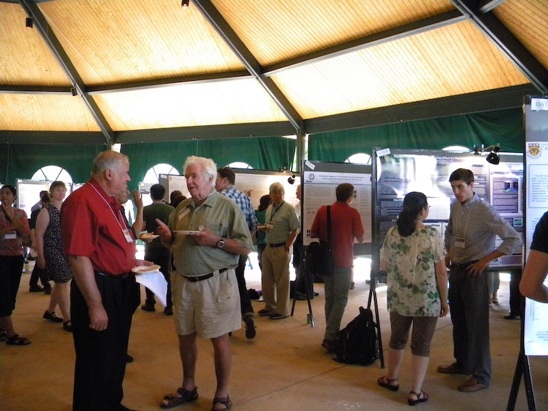 Wes Swartz (Cornell on left) talks with Bill Wright (retired from NOAA) at the IT poster session Tuesday 25 June 2013. In the background left to right are: ?, Delores Knipp (U CO), Sam Yee (APL/JHU) in front of Susan Nossal (U WI) explaining her #LTVI-03 poster to Vince Wickwar (USU), Nick Pedatella at #SOLA-03, and at #SOLA-07 Xiaoli Luan (USTC, China) listens to Ryan McGranaghan (U CO) explain his poster.