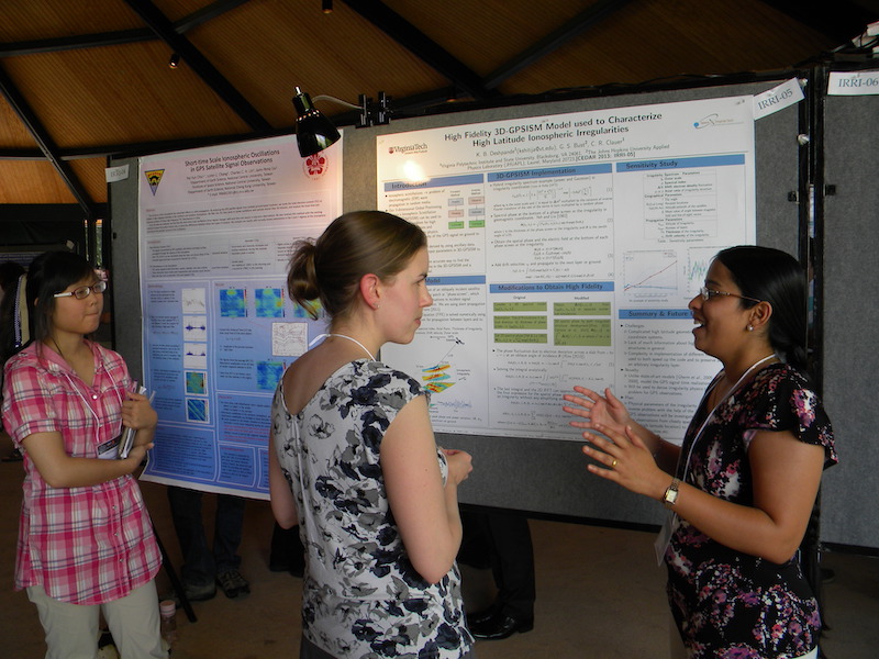 Elizabeth Bass Fucetola, IT poster judge, listens to Kshitija Deshpande (VT, honorable mention) describe her poster #IRRI-05 with Pei-Yun Chiu (NCU, Taiwan) of #IRRI-04 in the background.