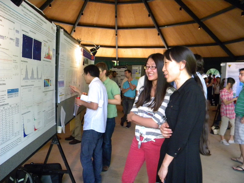Yu Jade Morton (Miami U) and her student Yu Jiao examine their poster #IRRI-09 together.