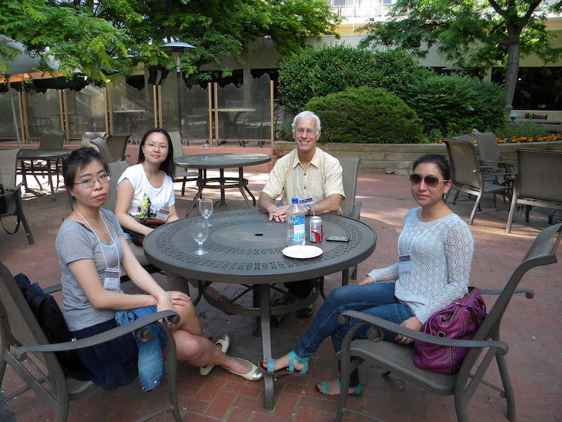 Relaxing on the patio of the Millennium Hotel from left to right: Ying Zou (UCLA), Shasha Zou (U MI), Larry Lyons (UCLA), Bea Gallardo-Lacourt (UCLA).