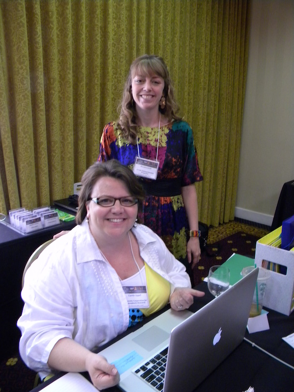 Carrie Appel (seated) and Kendra Greb of the Visiting Scientist Program at NCAR behind the CEDAR 2013 registration desk in the Millennium Hotel.