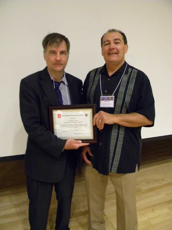 CSSC Chair David Hysell (Cornell) on left gives CEDAR Prize Lecturer #25 Jeff Forbes (U CO) his plaque of appreciation Monday June 23.