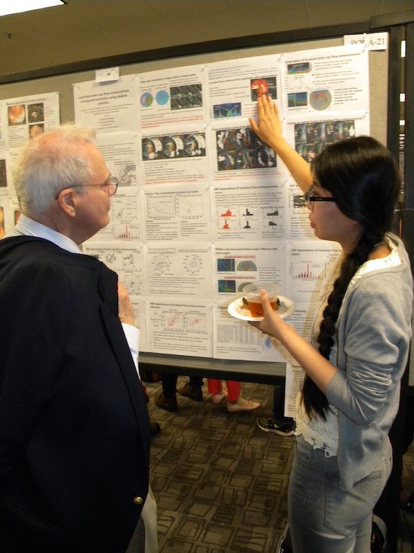 Ying Zou (UCLA) explains her poster SOLA-21 to Herb Carlson (USU).