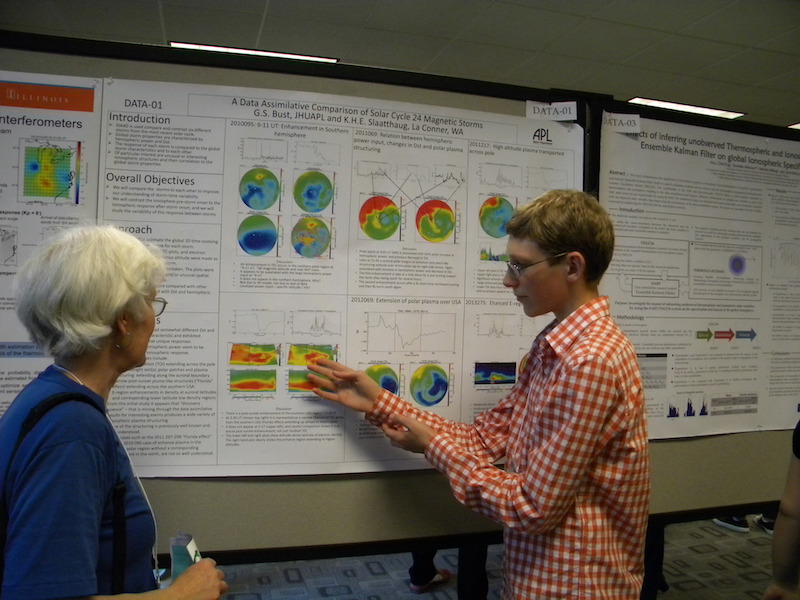 Barbara Emery (NCAR) listens to high school student Kaleb Slaatthaug (Mt Vernon, WA) explain the poster DATA-01 that he helped his mentor Gary Bust (APL/JHU) get plots for.