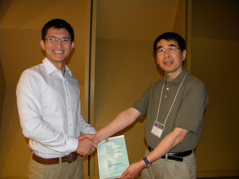 2013 CEDAR MLT first place winner Zhibin Yu (U CO, MLTL-11 in 2013) gets a different book prize, the Schunk and Nagy book "Ionospheres: Physics, Plasma Physics, and Chemistry", courtesy of Bob Schunk (USU) from 2013 chief MLT judge Qian Wu (NCAR).