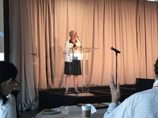 woman presenting at podium